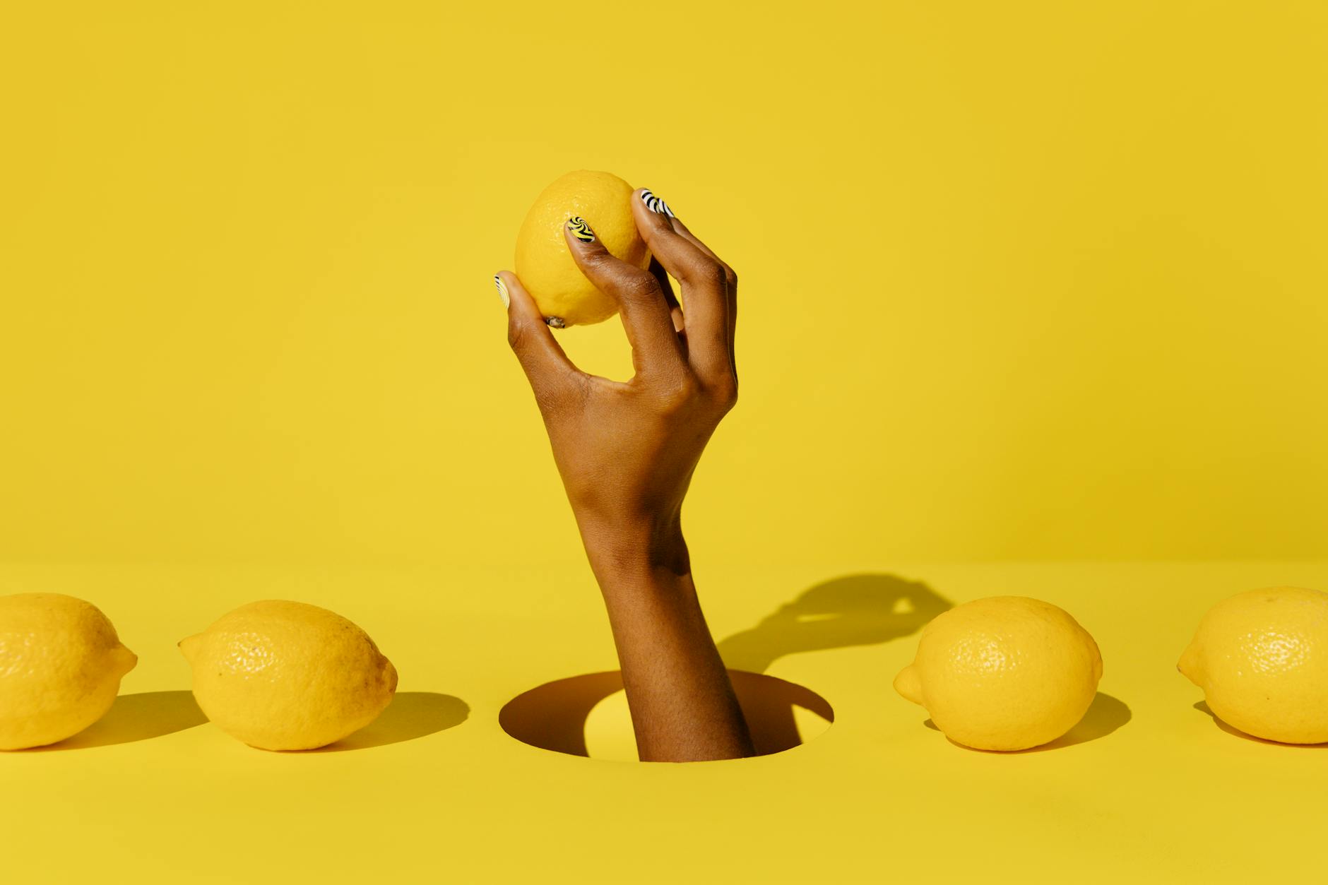 Yellow silicone vibrator surrounded by peeled bananas on a bright yellow background